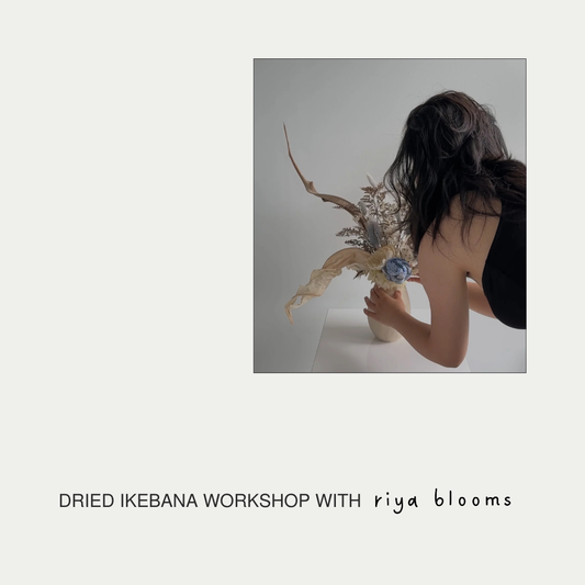 Person arranging dried flowers with text 'DRIED IKEBANA WORKSHOP WITH riya blooms' on a light gray background