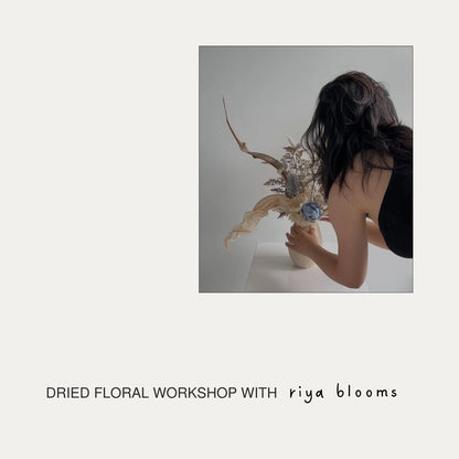 Person holding dried floral arrangement with text 'DRIED IKEBANA WORKSHOP WITH riya blooms' on a plain background