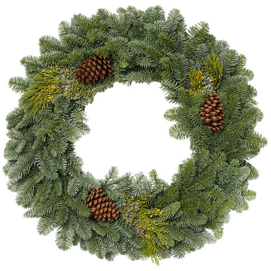 Green Christmas wreath with pine cones and berries on a white background