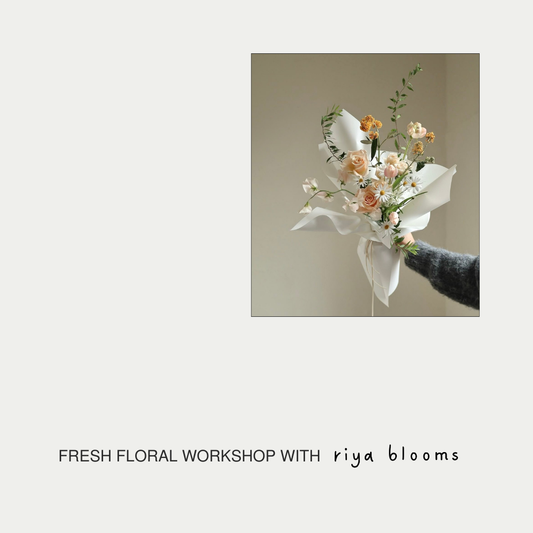 Floral arrangement with text 'Fresh Floral Workshop with riya blooms' on a light background