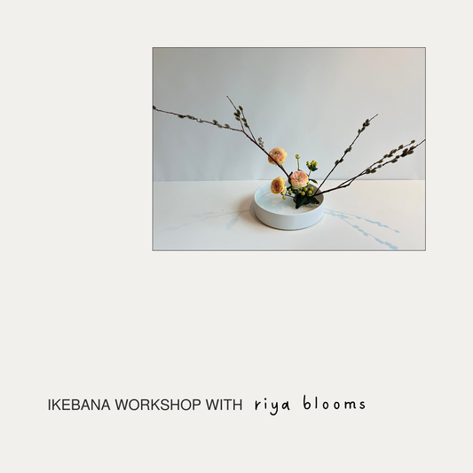 Floral arrangement in a white bowl on a light surface with 'Ikebana Workshop with riya blooms' text.