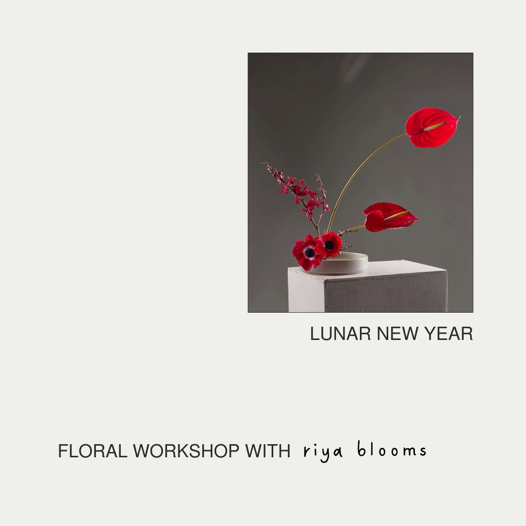 Floral arrangement with red flowers in a white vase on a gray background, promoting a floral workshop by riya blooms for Lunar New Year.