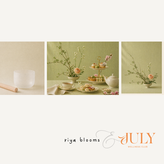 Tea set with flowers and snacks on a table, featuring 'riya blooms & July Wellness Club' branding.