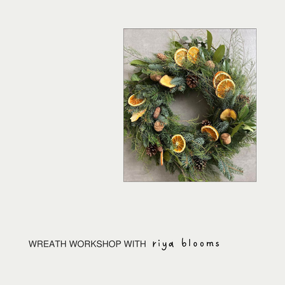 Decorative wreath with greenery, oranges, and pinecones on a light gray background with 'riya blooms' text.